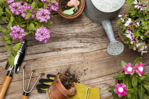 Gardener working in a Twickenham garden, close-up of hands and soil