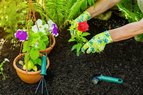 Worker using safety equipment while operating garden machinery